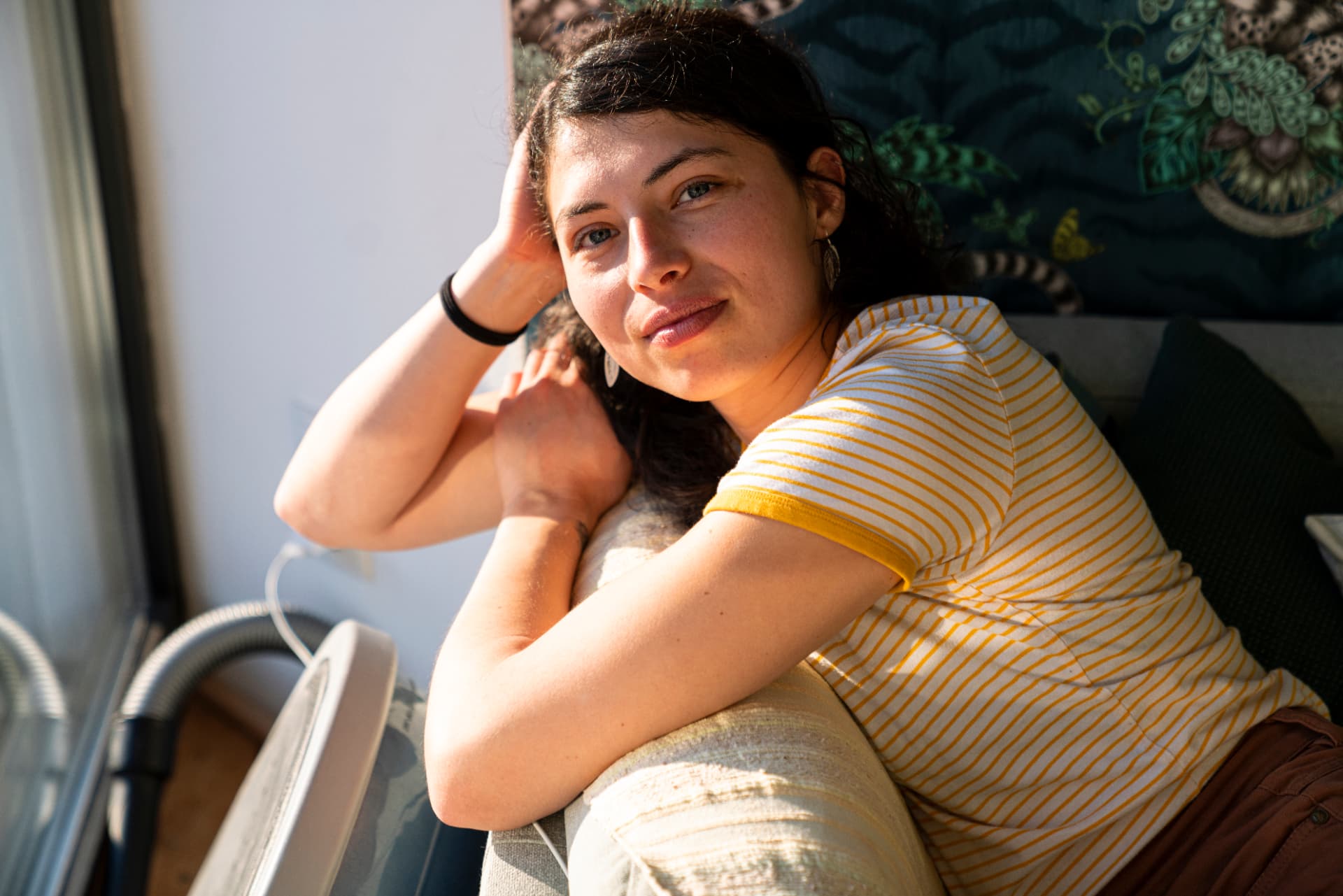 Woman smiling at home in warm sunlight